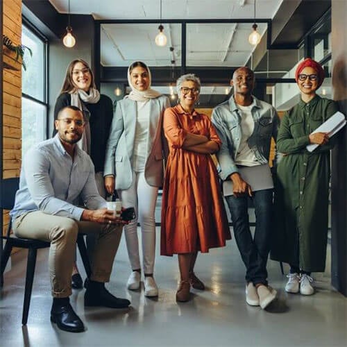 Group photo at workplace with diverse team smiling