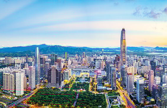 A panoramic view of the Shenzhen skyline at dusk, with the KK100 skyscraper